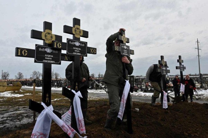 No cemitério de Kharkiv, cinco túmulos de família morta em ataque