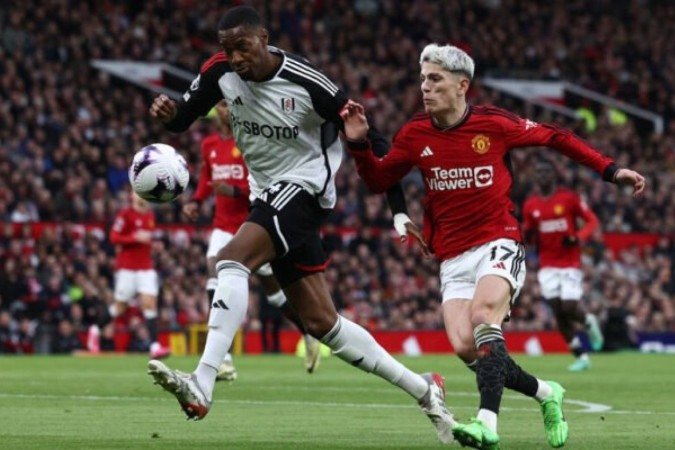 Bassey  (de branco) conclui para fazer o gol do Fulham sobre o Manchester United  -  -  (crédito: Foto:  Darren Staples / AFP via Getty Images)