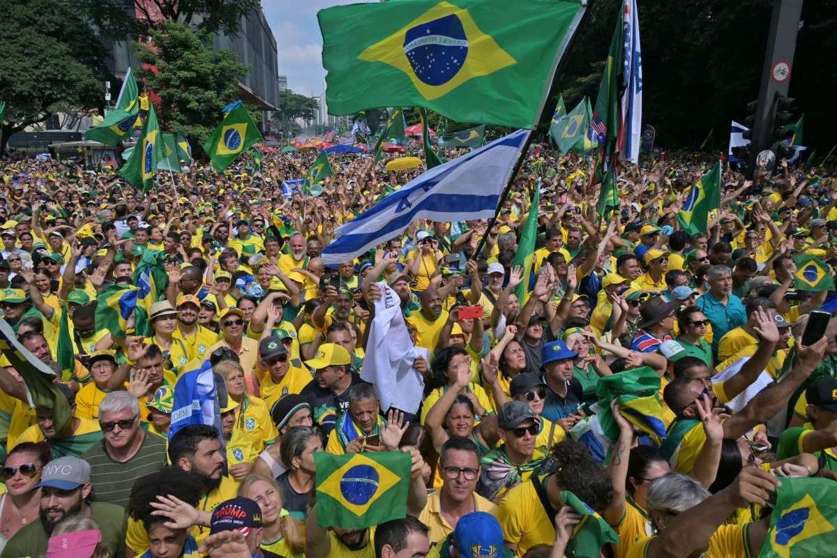  Supporters of former Brazilian President Jair Bolsonaro (2019-2022) attend a rally in Sao Paulo, Brazil, on February 25, 2024, to reject claims he plotted a coup with allies to remain in power after his failed 2022 reelection bid. Investigators say the far-right ex-army captain led a plot to falsely discredit the Brazilian election system and prevent the winner of the vote, leftist President Luiz Inacio Lula da Silva, from taking power. A week after Lula took office on January 1, 2023, thousands of Bolsonaro supporters stormed the presidential palace, Congress and Supreme Court, urging the military to intervene to overturn what they called a stolen election. (Photo by NELSON ALMEIDA / AFP)       
