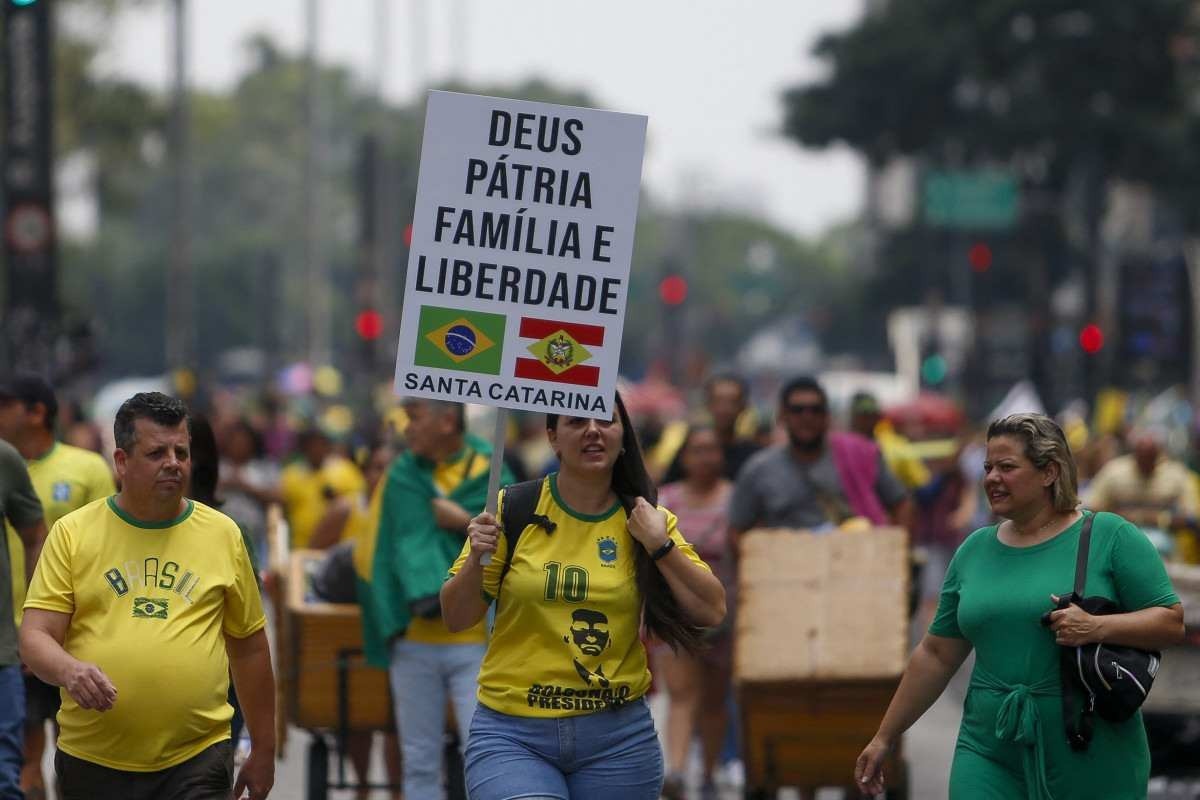  Supporters of former Brazilian President Jair Bolsonaro (2019-2022) attend a rally in Sao Paulo, Brazil, on February 25, 2024, to reject claims he plotted a coup with allies to remain in power after his failed 2022 reelection bid. Investigators say the far-right ex-army captain led a plot to falsely discredit the Brazilian election system and prevent the winner of the vote, leftist President Luiz Inacio Lula da Silva, from taking power. A week after Lula took office on January 1, 2023, thousands of Bolsonaro supporters stormed the presidential palace, Congress and Supreme Court, urging the military to intervene to overturn what they called a stolen election. (Photo by Miguel SCHINCARIOL / AFP)       
