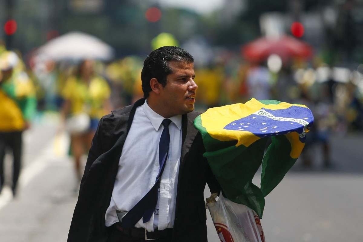  A supporter of former Brazilian President Jair Bolsonaro (2019-2022) attends a rally in Sao Paulo, Brazil, on February 25, 2024, to reject claims he plotted a coup with allies to remain in power after his failed 2022 reelection bid. Investigators say the far-right ex-army captain led a plot to falsely discredit the Brazilian election system and prevent the winner of the vote, leftist President Luiz Inacio Lula da Silva, from taking power. A week after Lula took office on January 1, 2023, thousands of Bolsonaro supporters stormed the presidential palace, Congress and Supreme Court, urging the military to intervene to overturn what they called a stolen election. (Photo by Miguel SCHINCARIOL / AFP)       