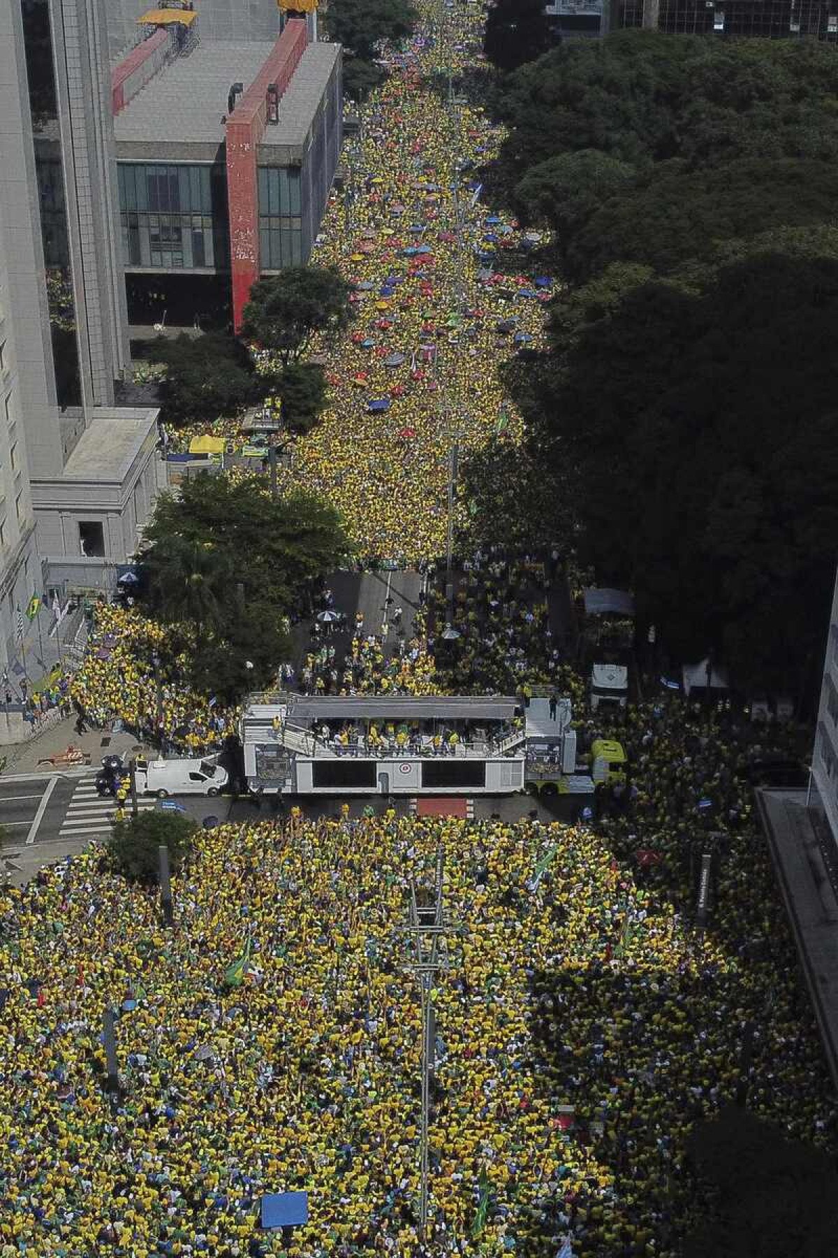  Aerial view showing supporters of former Brazilian President Jair Bolsonaro (2019-2022) attending a rally in Sao Paulo, Brazil, on February 25, 2024, to reject claims he plotted a coup with allies to remain in power after his failed 2022 reelection bid. Investigators say the far-right ex-army captain led a plot to falsely discredit the Brazilian election system and prevent the winner of the vote, leftist President Luiz Inacio Lula da Silva, from taking power. A week after Lula took office on January 1, 2023, thousands of Bolsonaro supporters stormed the presidential palace, Congress and Supreme Court, urging the military to intervene to overturn what they called a stolen election. (Photo by Miguel SCHINCARIOL / AFP)       