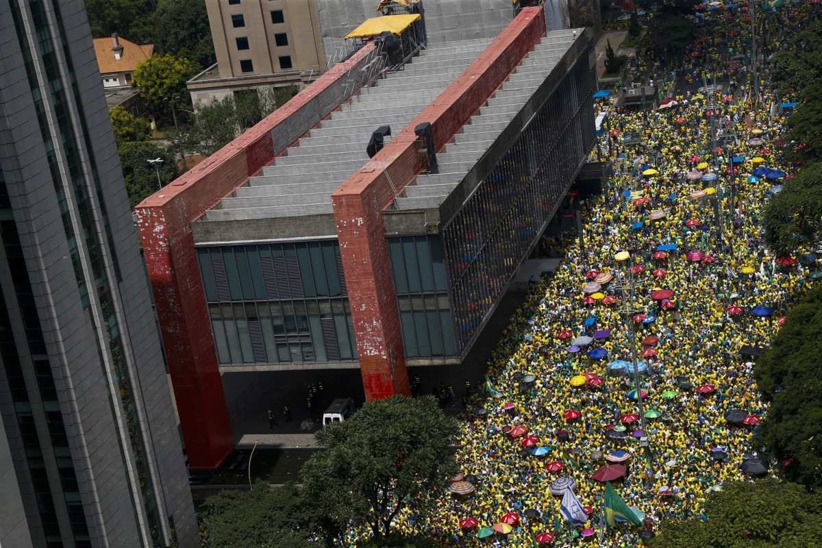  Aerial view showing supporters of former Brazilian President Jair Bolsonaro (2019-2022) attending a rally in Sao Paulo, Brazil, on February 25, 2024, to reject claims he plotted a coup with allies to remain in power after his failed 2022 reelection bid. Investigators say the far-right ex-army captain led a plot to falsely discredit the Brazilian election system and prevent the winner of the vote, leftist President Luiz Inacio Lula da Silva, from taking power. A week after Lula took office on January 1, 2023, thousands of Bolsonaro supporters stormed the presidential palace, Congress and Supreme Court, urging the military to intervene to overturn what they called a stolen election. (Photo by Miguel SCHINCARIOL / AFP)       