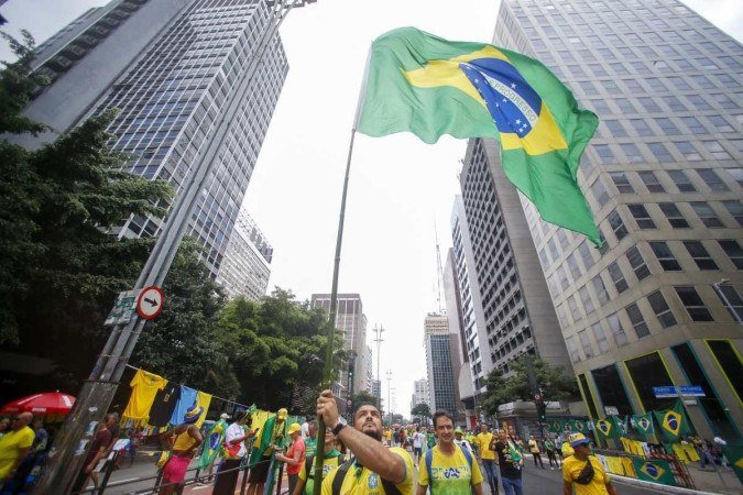  Supporters of former Brazilian President Jair Bolsonaro (2019-2022) attend a rally in Sao Paulo, Brazil, on February 25, 2024, to reject claims he plotted a coup with allies to remain in power after his failed 2022 reelection bid. Investigators say the far-right ex-army captain led a plot to falsely discredit the Brazilian election system and prevent the winner of the vote, leftist President Luiz Inacio Lula da Silva, from taking power. A week after Lula took office on January 1, 2023, thousands of Bolsonaro supporters stormed the presidential palace, Congress and Supreme Court, urging the military to intervene to overturn what they called a stolen election. (Photo by Miguel SCHINCARIOL / AFP)
      