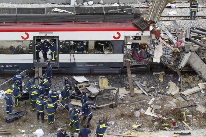  (FILES) Bodies of victims are evacuated after a train exploded at the Atocha train station in Madrid, on March 11, 2004. Spain marks the 20th anniversary of the attack that caused nearly 200 fatal victims, claimed by 