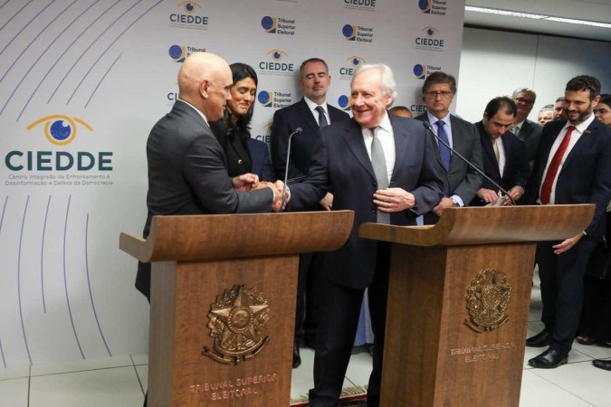 Moraes e Lewandowski se cumprimentam após assinarem o protocolo do Ciedde. Ambos prometeram punir severamente manipulações eleitorais -  (crédito: Luiz Roberto/Secom/TSE)