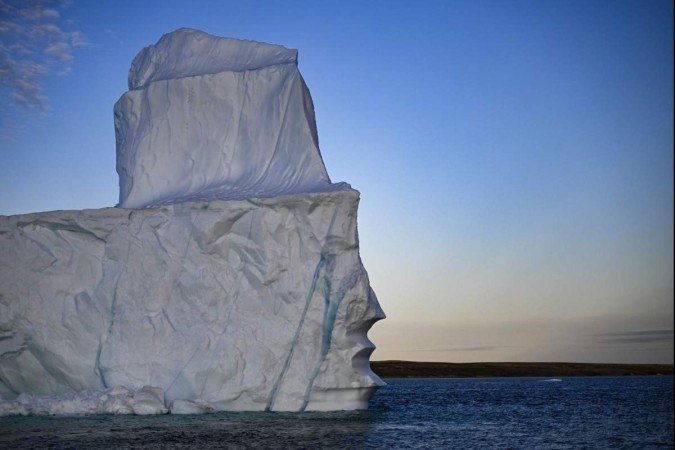  (FILES) A melting iceberg drifts due to high temperatures in Scoresby Fjord near Ittoqqortoormiit, Greenland, on August 12, 2023. Global temperatures 