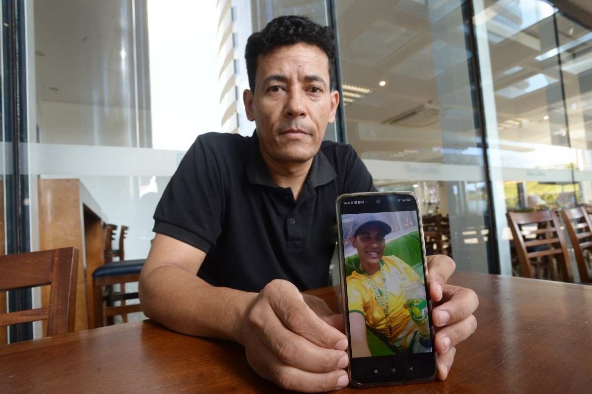  Marcelo dos Santos mostra a foto do filho, Johnathan Diogo de Oliveira, uma das vítimas da brutalidade na batalha extracampo entre as organizadas  