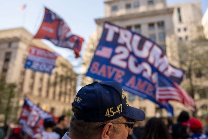  NEW YORK, NEW YORK - APRIL 15: Trump supporters gather at Collect Pond Park near Manhattan Criminal Court on April 15, 2024 in New York City. Jury selection is set to begin in the former president's criminal trial. Trump faces 34 felony counts of falsifying business records in the first of his criminal cases to go to trial. This is the first-ever criminal trial of a former president of the United States.   David Dee Delgado/Getty Images/AFP (Photo by David Dee Delgado / GETTY IMAGES NORTH AMERICA / Getty Images via AFP)
      