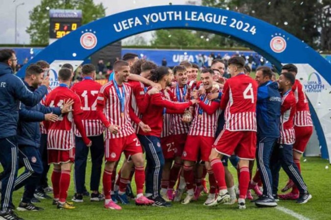  Olympiacos' players celebrate with the trophy after wining the UEFA Youth League final fooball match between Olympiacos and AC Milan at Colovray Sport Center in Nyon, on April 22, 2024. (Photo by Fabrice COFFRINI / AFP) (Photo by FABRICE COFFRINI/AFP via Getty Images)
     -  (crédito:  AFP via Getty Images)
