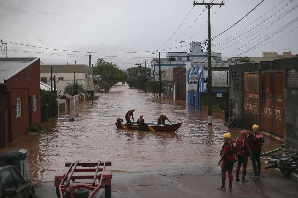  A team of firefighters work at a flooded street in the city center of Sao Sebastiao do Cai, Rio Grande do Sul state, Brazil on May 2, 2024. The death toll from a severe storm in Rio Grande do Sul, in southern Brazil, rose to 13, amid the 