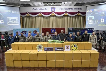 O chefe interino da Polícia Nacional da Tailândia, Kittharath Punpetch (centro L) e o vice-primeiro-ministro Anutin Charnvirakul (centro R) estão ao lado de outros oficiais em frente a caixas de metanfetamina cristal, durante uma conferência de imprensa em Bangkok em 12 de maio de 2024 -  (crédito: Tananchai KEAWSOWATTANA / THAI NEWS PIX / AFP)