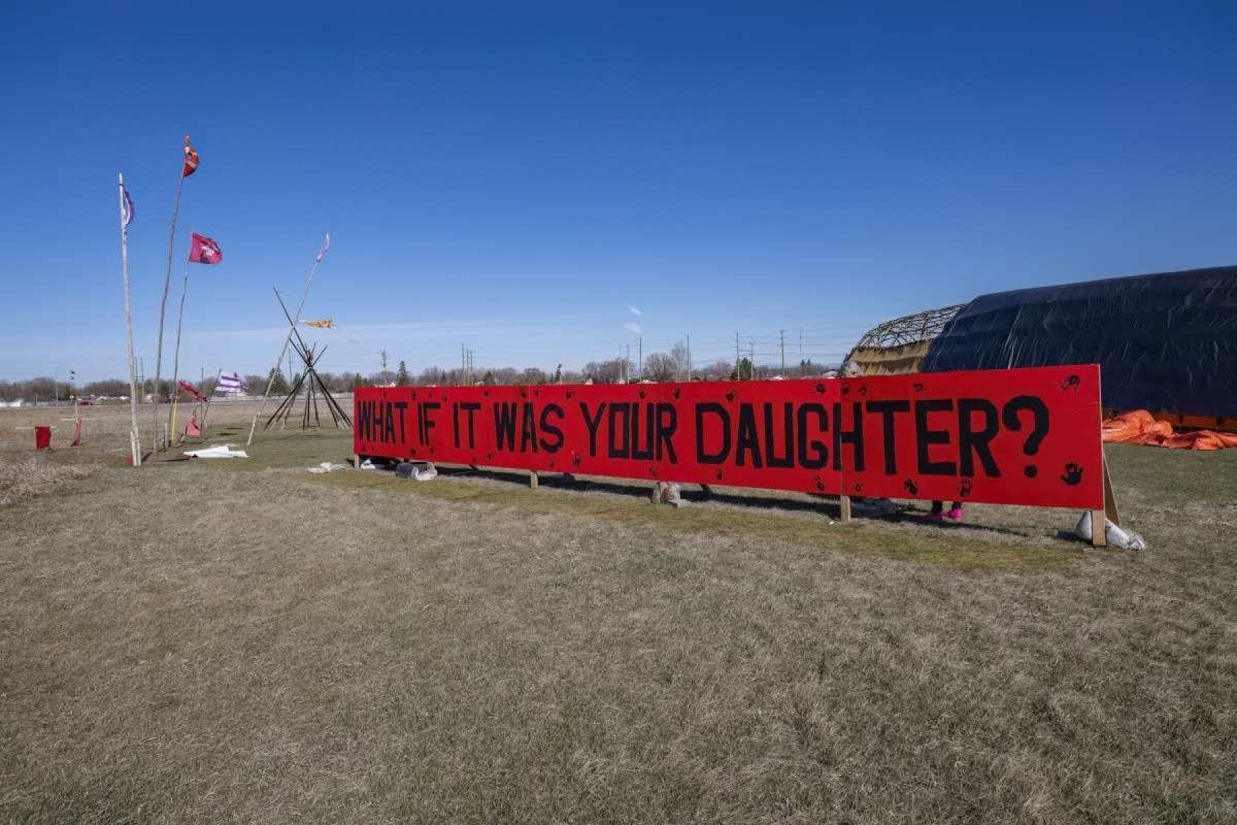  A sign is displayed at the entrance of a makeshift camp near near the Prairie Green landfill in Winnipeg, Manitoba, Canada, on April 27, 2024. The camp set up by the family of slained Morgan Harris take turns staying in the camp, seeking, says Morgan's daughter Elle Harris, 