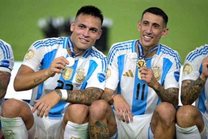  Argentina's forward #22 Lautaro Martinez (L) and Argentina's forward #11 Angel Di Maria pose with their medals following their team's victory in the Conmebol 2024 Copa America tournament final football match between Argentina and Colombia at the Hard Rock Stadium, in Miami, Florida on July 14, 2024. (Photo by JUAN MABROMATA / AFP)
     -  (crédito:  AFP via Getty Images)