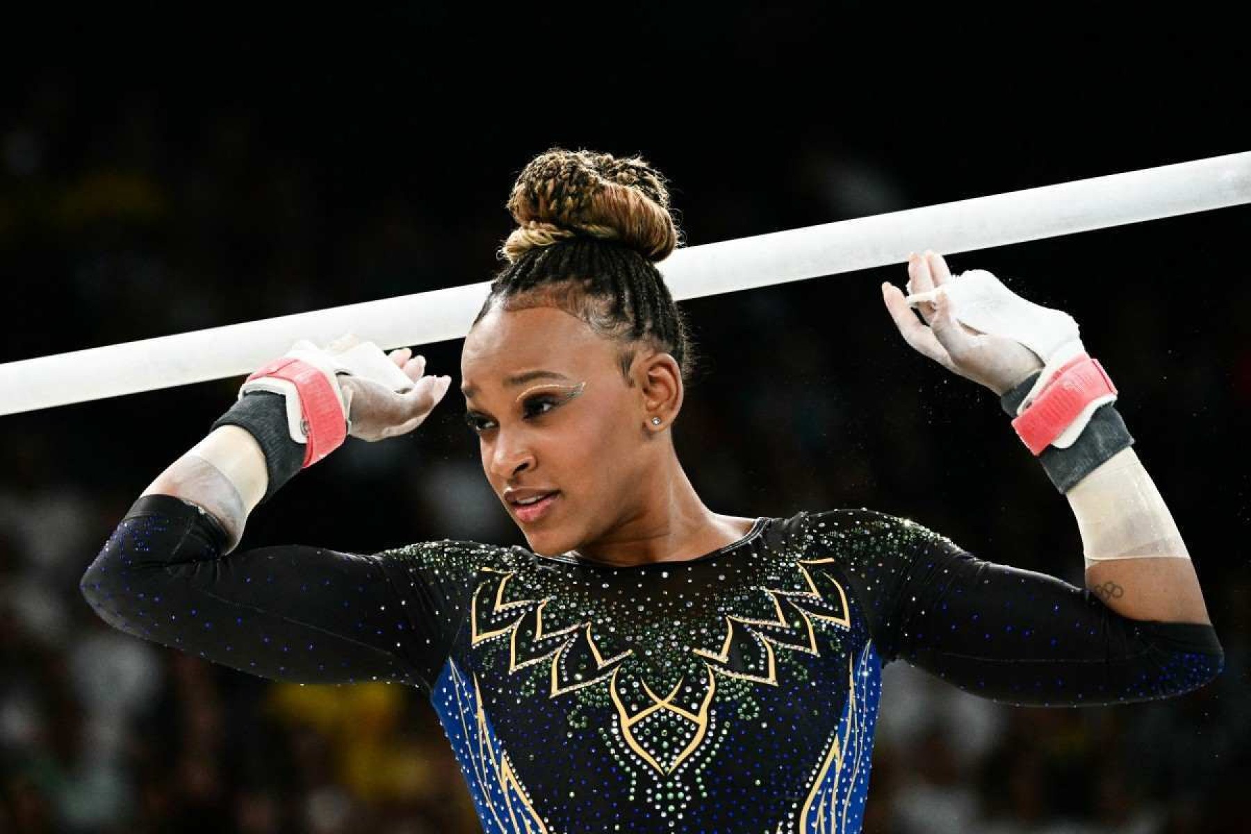  Brazils Rebeca Andrade prepares to compete in the uneven bars event of the artistic gymnastics womens qualification during the Paris 2024 Olympic Games at the Bercy Arena in Paris, on July 28, 2024. (Photo by Loic VENANCE / AFP)       