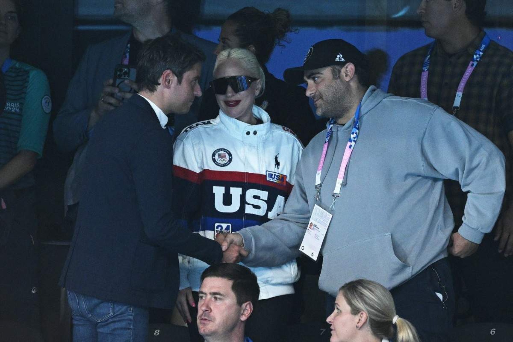  US singer and actress Lady Gaga (C) and Frances Prime Minister Gabriel Attal (L) attend the swimming event during the Paris 2024 Olympic Games at the Paris La Defense Arena in Nanterre, west of Paris, on July 28, 2024. (Photo by Oli SCARFF / AFP)       