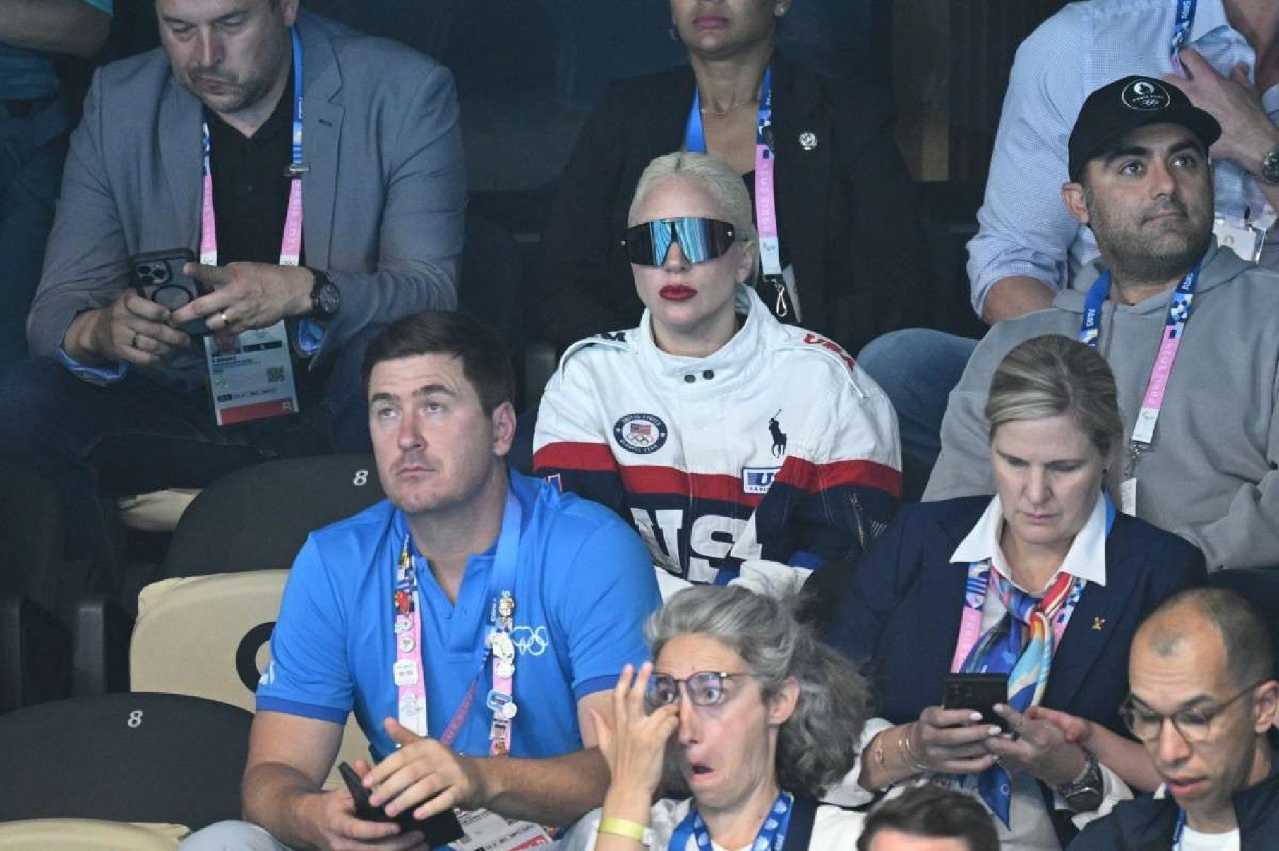  US singer and actress Lady Gaga (C) attends the swimming event during the Paris 2024 Olympic Games at the Paris La Defense Arena in Nanterre, west of Paris, on July 28, 2024. (Photo by Oli SCARFF / AFP)       