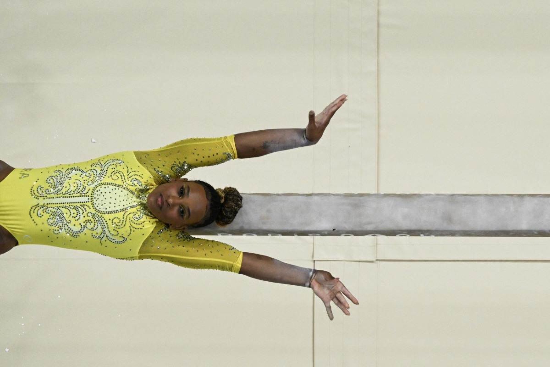  An overview shows Brazils Rebeca Andrade competing in the balance beam event of the artistic gymnastics womens all around final during the Paris 2024 Olympic Games at the Bercy Arena in Paris, on August 1, 2024. (Photo by Martin BUREAU / AFP)       