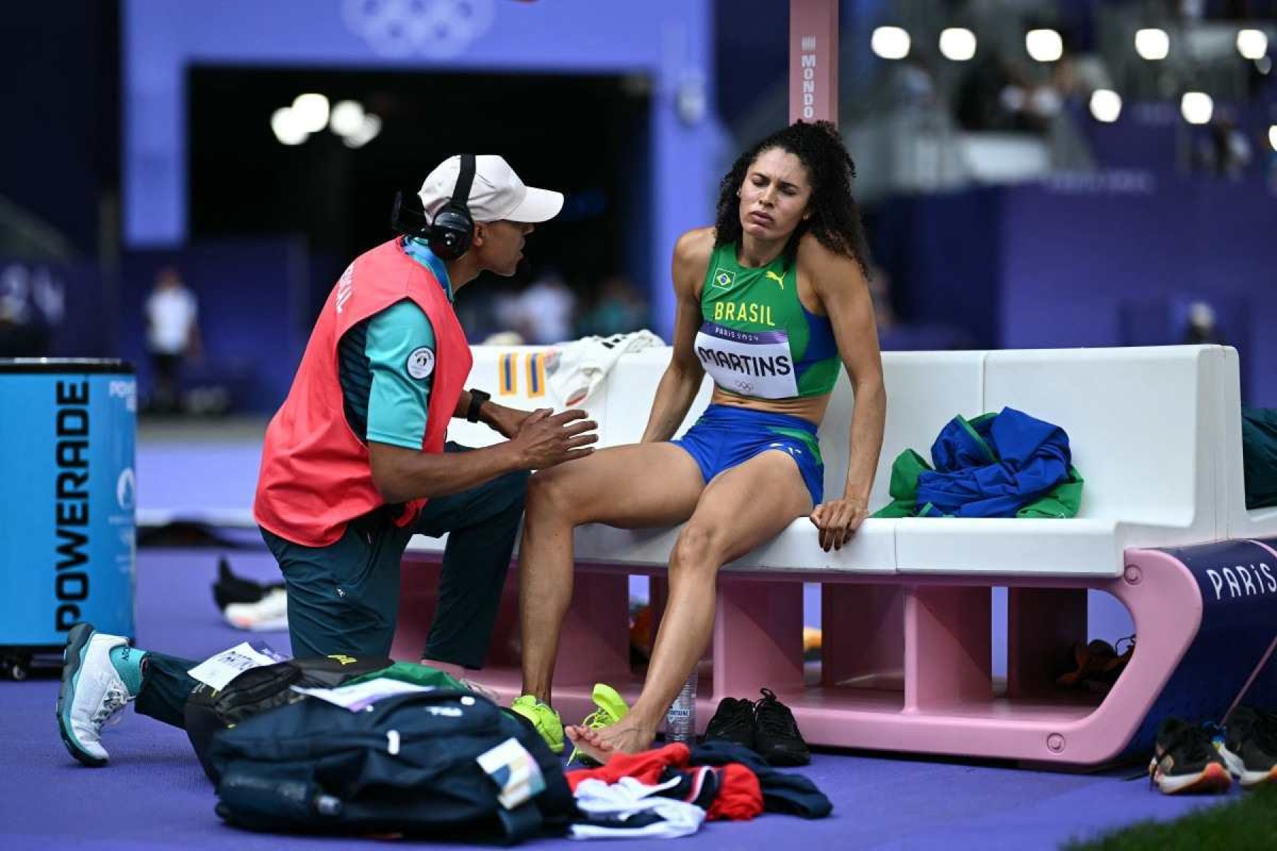  Brazils Valdileia Martins receives medical attention as she competes in the womens high jump qualification of the athletics event at the Paris 2024 Olympic Games at Stade de France in Saint-Denis, north of Paris, on August 2, 2024. (Photo by Ben STANSALL / AFP)       