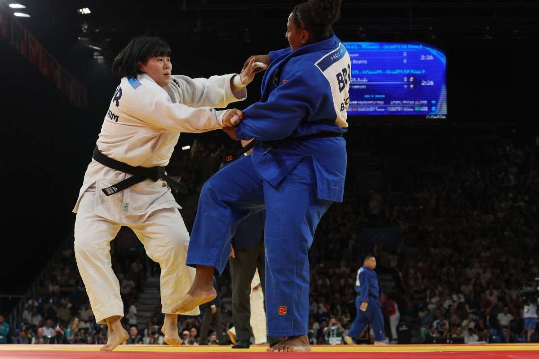  South Koreas Kim Hay-un and Brazils Beatriz Souza (Blue) compete in the judo womens +78kg quarter-final bout of the Paris 2024 Olympic Games at the Champ-de-Mars Arena, in Paris on August 2, 2024. (Photo by Jack GUEZ / AFP)       