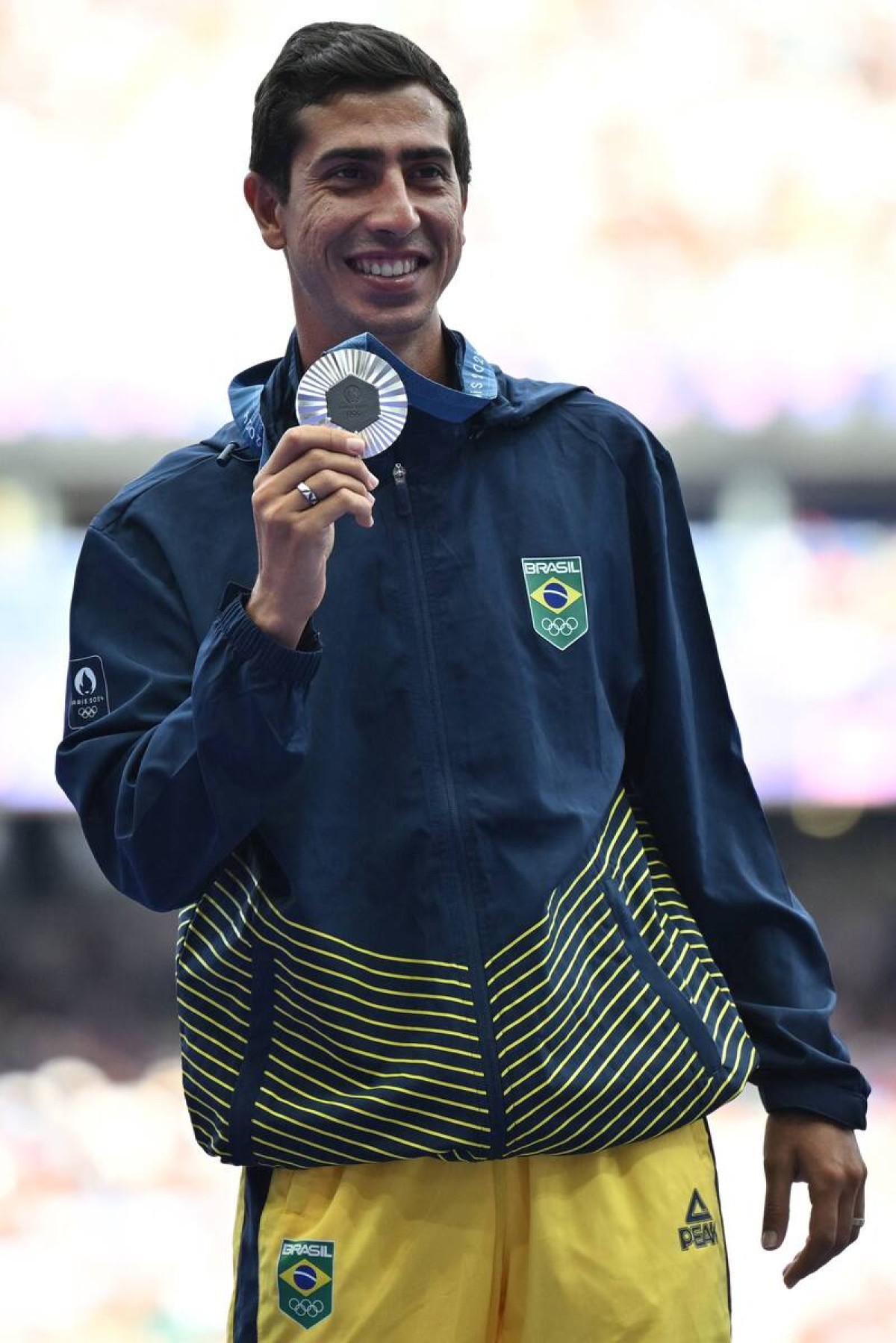  Silver Medalist Brazils Caio Bonfim celebrates on the podium after competing in the mens 20km race walk of the athletics event, at the Paris 2024 Olympic Games at Stade de France in Saint-Denis, north of Paris, on August 2, 2024. (Photo by Andrej ISAKOVIC / AFP)       