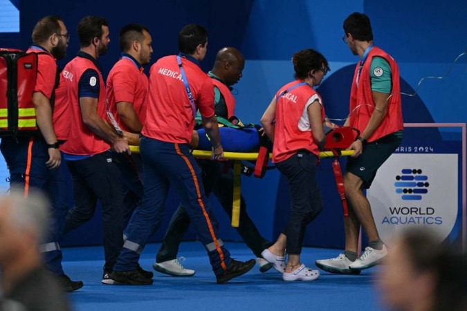 A equipe médica carrega Tamara Potocka da Eslováquia em uma maca depois que ela desmaiou após uma bateria dos 200m medley -  (crédito: Jonathan NACKSTRAND/AFP)