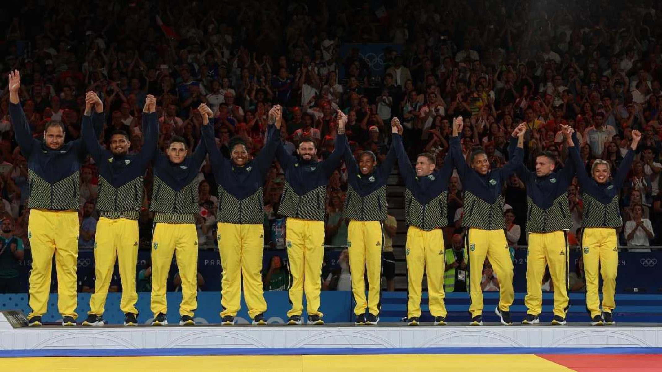  Bronze medallists team Brazil celebrate on the podium of the judo mixed team event at the Paris 2024 Olympic Games in the Champ-de-Mars Arena, in Paris on August 3, 2024. (Photo by Jack GUEZ / AFP) / ALTERNATE CROP       