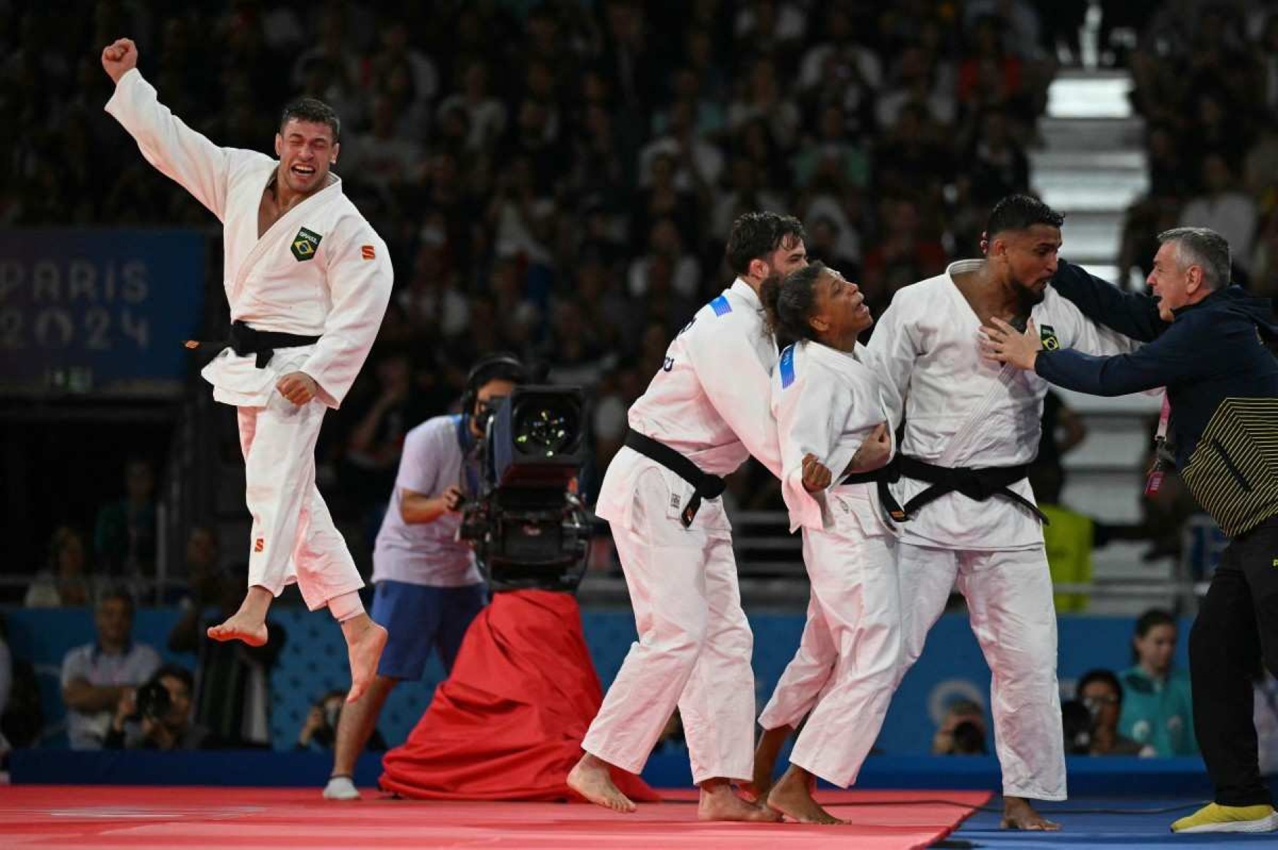 A seleção brasileira comemora a conquista da medalha de bronze do judô misto entre Brasil e Itália nos Jogos Olímpicos de Paris 2024, na Arena Champ-de-Mars, em Paris, no dia 3 de agosto de 2024.