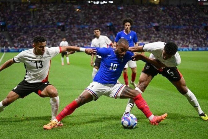 Lacazette em disputa de bola com jogadores do Egito  -  (crédito: Foto: Olivier Chassignole/AFP via Getty Images)