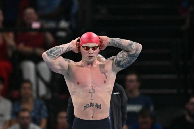 Nadador relata presença de vermes em comida na Vila Olímpica -  (crédito: Foto: MANAN VATSYAYANA/AFP via Getty Images)