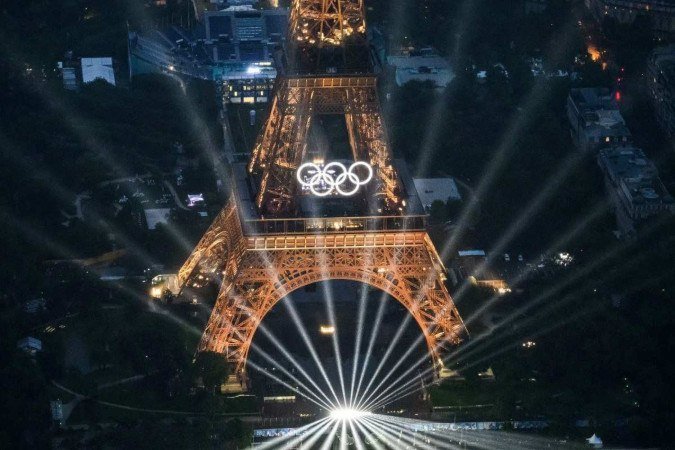 A photograph taken from an helicopter on July 26, 2024 shows an aerial view of the Eiffel Tower and the Olympics Rings lightened up during the opening ceremony of the Paris 2024 Olympic Games in Paris.