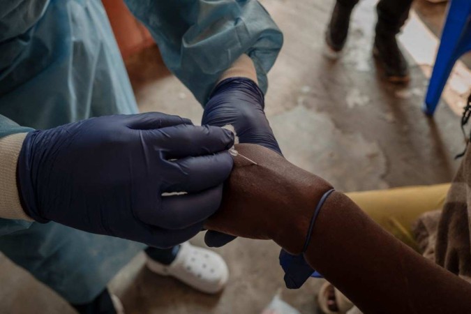  A health worker takes a sample at the Mpox treatment centre of the Nyiragongo general referral hospital, north of the town of Goma in the Democratic Republic of Congo, on August 16, 2024. Health Minister Samuel-Roger Kamba said in a video message that the country 