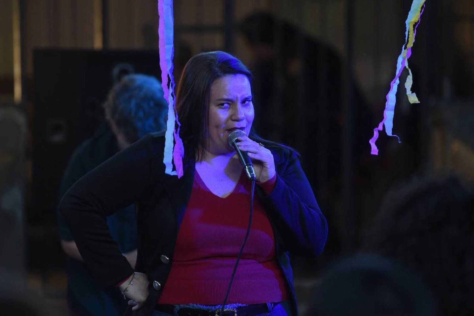  An inmate performs her monologue during the closing of a stand-up comedy workshop at the El Buen Pastor womens prison in Asuncion on August 10, 2024. The Paraguayan NGO Corazon Libre (Free Heart) held a two-month stand-up comedy workshop with the participation of a dozen inmates to help them reintegrate into the labor market upon their release from prison. (Photo by DANIEL DUARTE / AFP)       