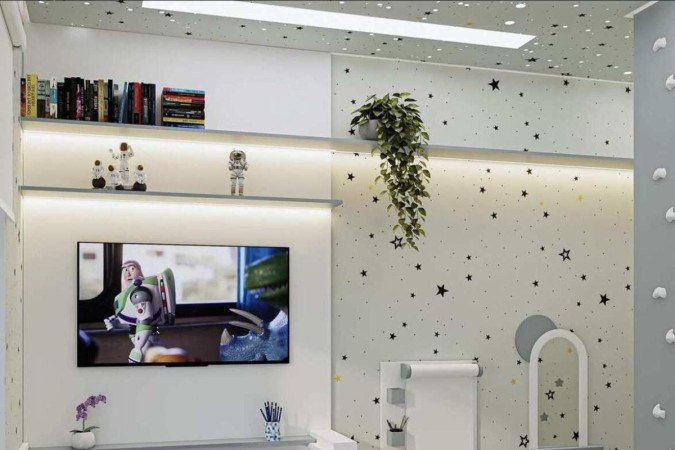 O cômodo tem também um espelho com apoio, mesa para atividades e até uma espécie de cavalete para desenho na parede 