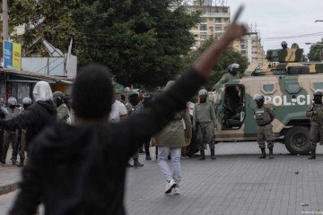 Agentes da policia de choque de Moçambique bloqueiam estrada em Maputo, na capital, durante protestos após as eleições de 9 de outubro -  (crédito: Alfredo Zuniga/AFP)