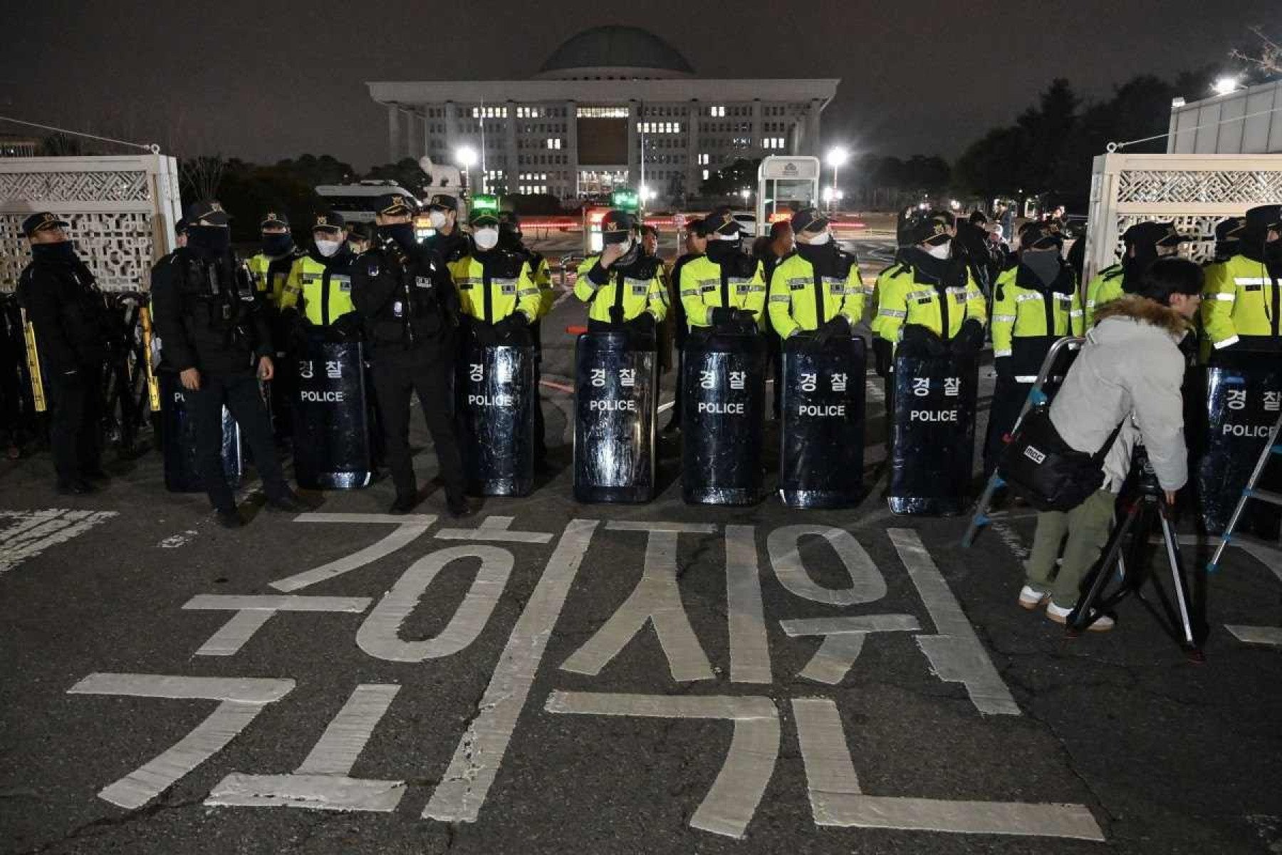  Police stand guard in front of the main gate of the National Assembly in Seoul, South Korea on December 3, 2024, after President Yoon Suk Yeol declared emergency martial law. South Koreas President Yoon Suk Yeol on December 3 declared emergency martial law, saying the step was necessary to protect the country from 