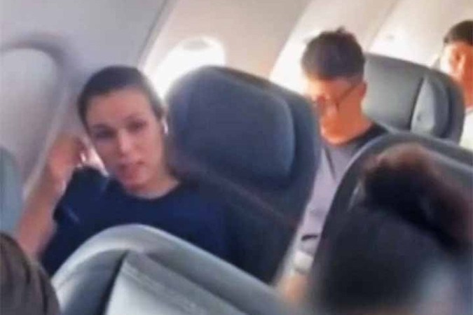 O vídeo mostra Jennifer Castro acomodada em um assento próximo à janela do avião com fones de ouvido e tentando ignorar a mulher que a constrange e hostiliza com a filmagem. Ela chega a fechar os olhos para tentar dar fim à polêmica.
 -  (crédito:  Reprodução de vídeo TV Globo)