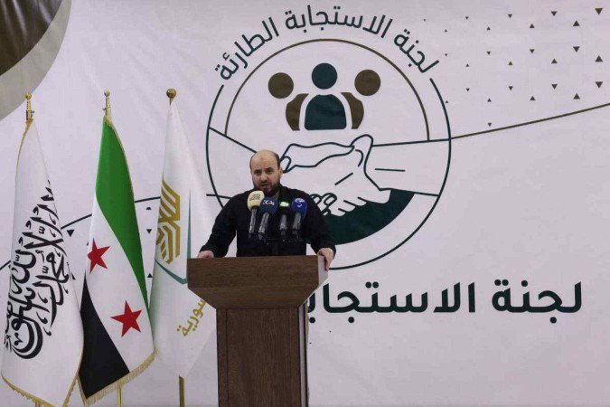  (FILES) Head of Islamist rebel group Hayat Tahrir al-Sham's (HTS) 'Salvation Government' in their northwest Syria bastion Mohammed Bashir, holds a press conference in the rebel-held northwestern Syrian city of Idlib on November 28, 2024. The Syrian rebels now in power in Damascus have appointed Mohammed al-Bashir as head of a transitional government that will be in place until March 1, state media said on December 10, 2024. (Photo by Omar HAJ KADOUR / AFP)
      