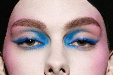 As maçãs do rosto são realçadas com blush em bastão de tom rosado, criando um efeito mais marcante