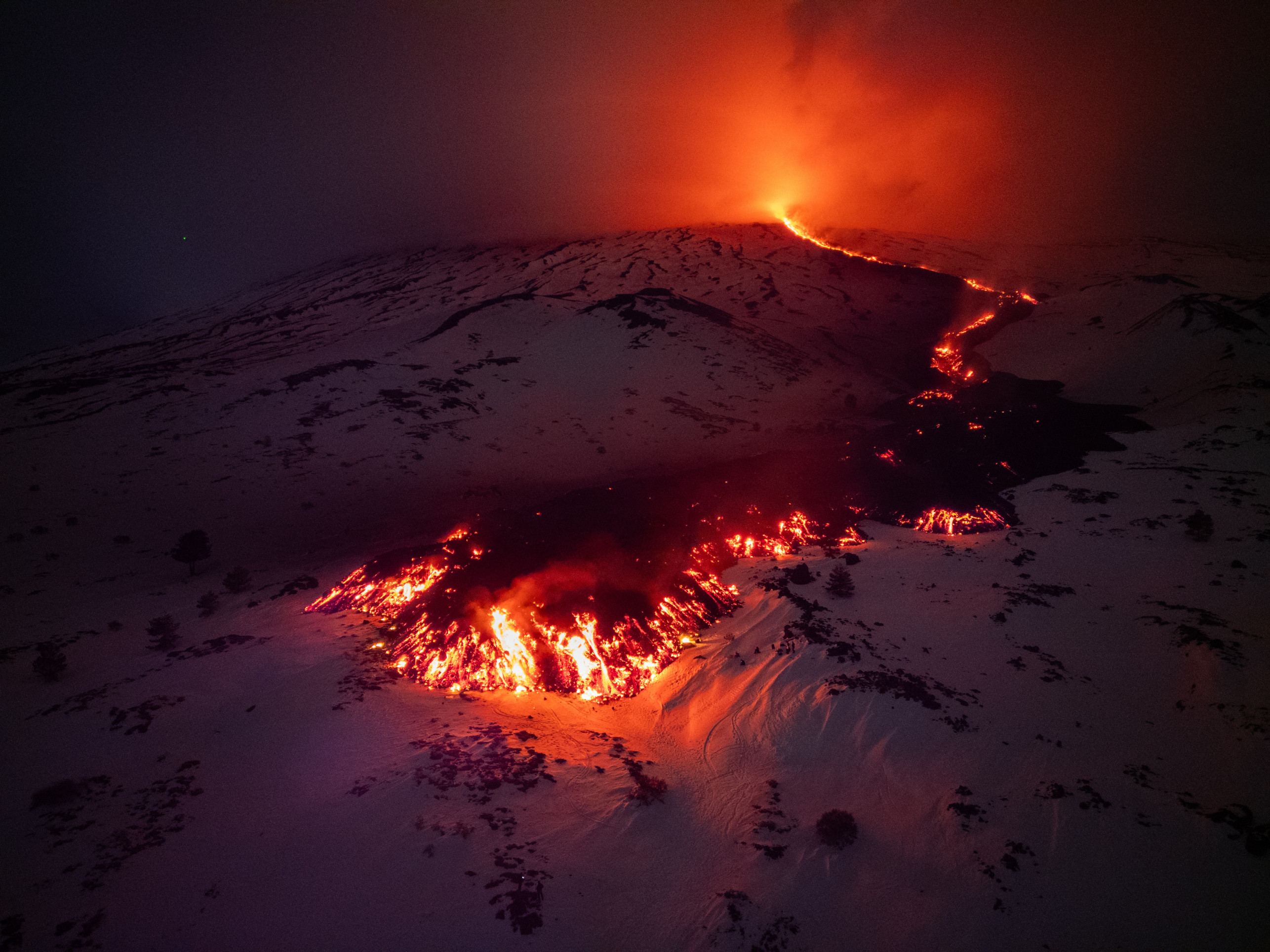  Lava flows from a fracture on the Mount Etna during an eruption of the volcano on February 14, 2025. (Photo by Etna Walk / AFP)       