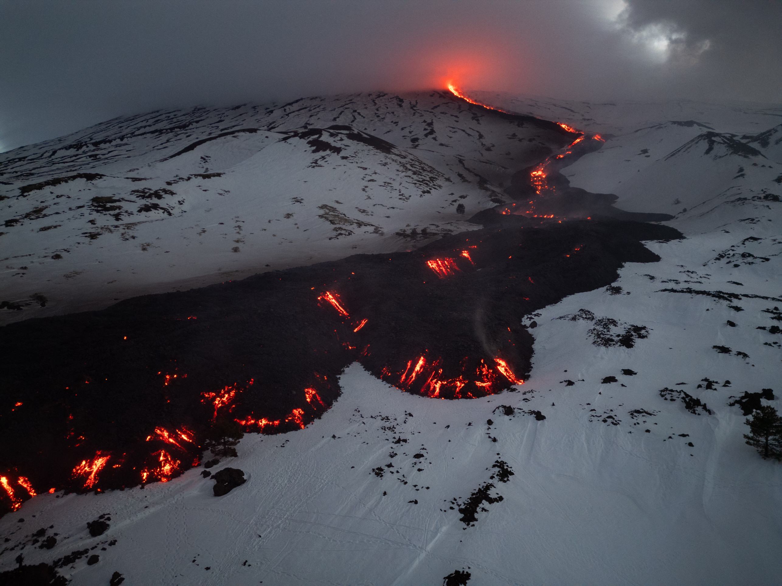  Lava flows from a fracture on the Mount Etna during an eruption of the volcano on February 14, 2025. (Photo by Etna Walk / AFP)       