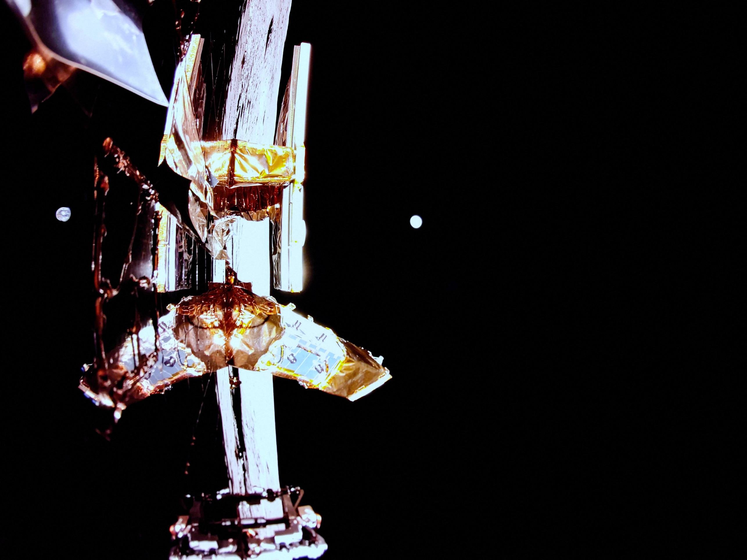  This handout photograph taken and released by Firefly Aerospace on March 2, 2025, shows the Moons surface, Earth on the horizon, and Blue Ghosts top deck with its solar panel, X-band antenna (L), and LEXI payload (R) in the view. A US company successfully landed its spacecraft on the Moon on March 2, 2025, making it only the second private lander to achieve this milestone, a live webcast from mission control showed. Firefly Aerospaces Blue Ghost Mission 1 touched down at 3:34 am US Eastern Time (0834 GMT) near Mons Latreille, a volcanic formation in Mare Crisium on the Moons northeastern near side. (Photo by Handout / Firefly Aerospace / AFP) / RESTRICTED TO EDITORIAL USE - MANDATORY CREDIT 