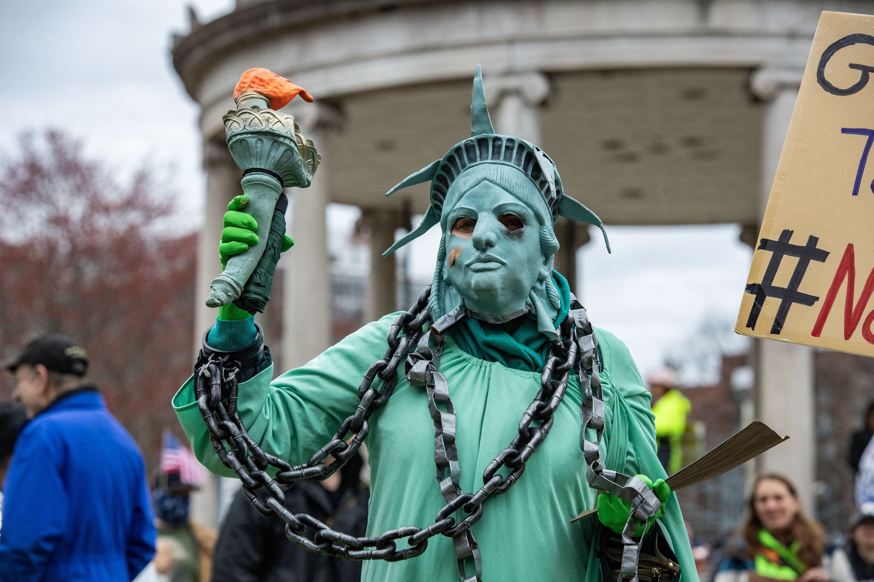 Manifestante fantasiado de Esttua da Liberdade acorrentada, em Boston 