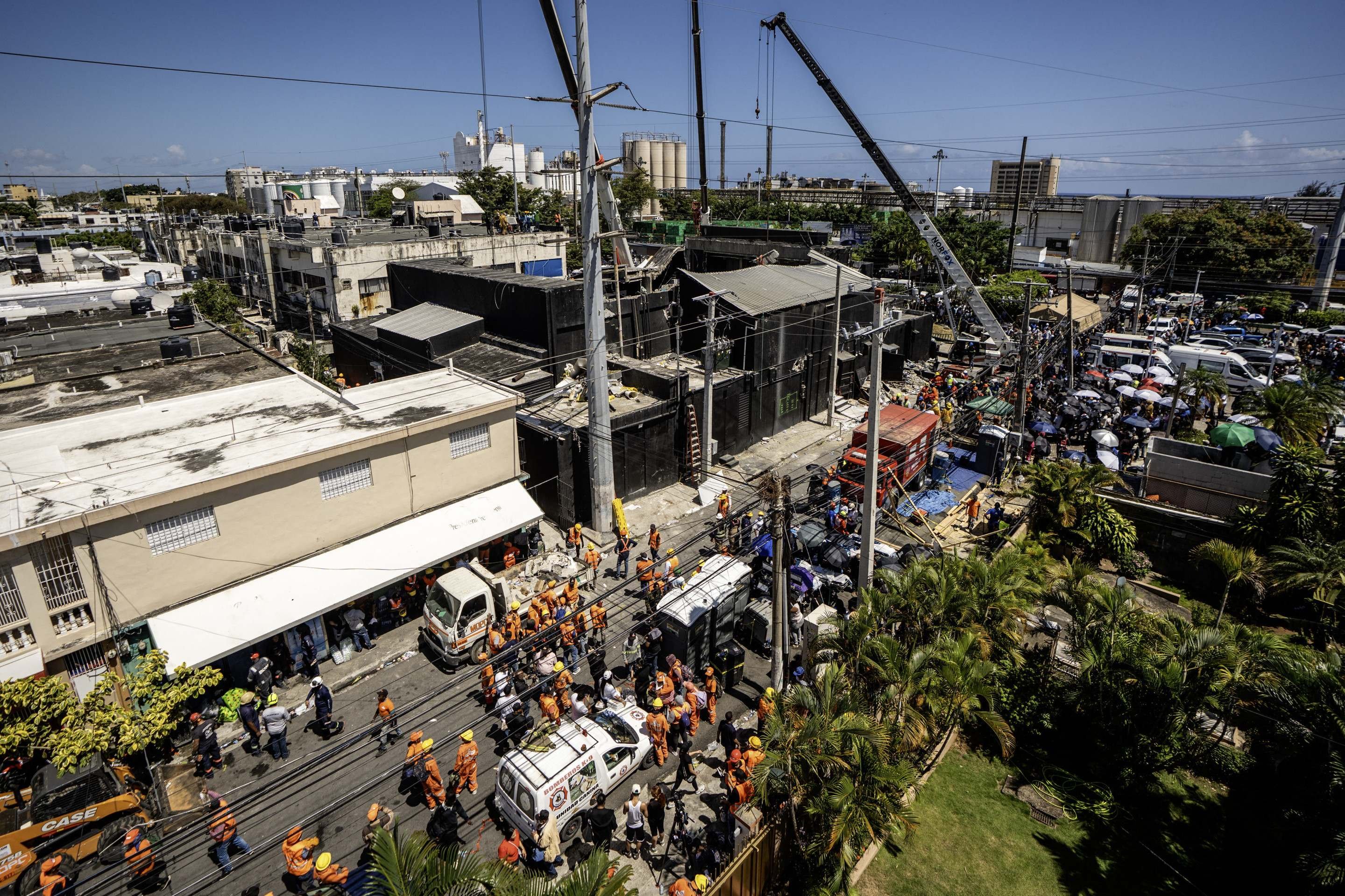  Personnel from civil defense and firefighters work at the Jet Set nightclub following the collapse of its roof in Santo Domingo on April 8, 2025. Rescuers raced to find survivors Tuesday among the rubble of a Dominican Republic night club where at least 44 people died and dozens were hurt in an early-morning roof collapse. (Photo by Francesco SPOTORNO / AFP)       