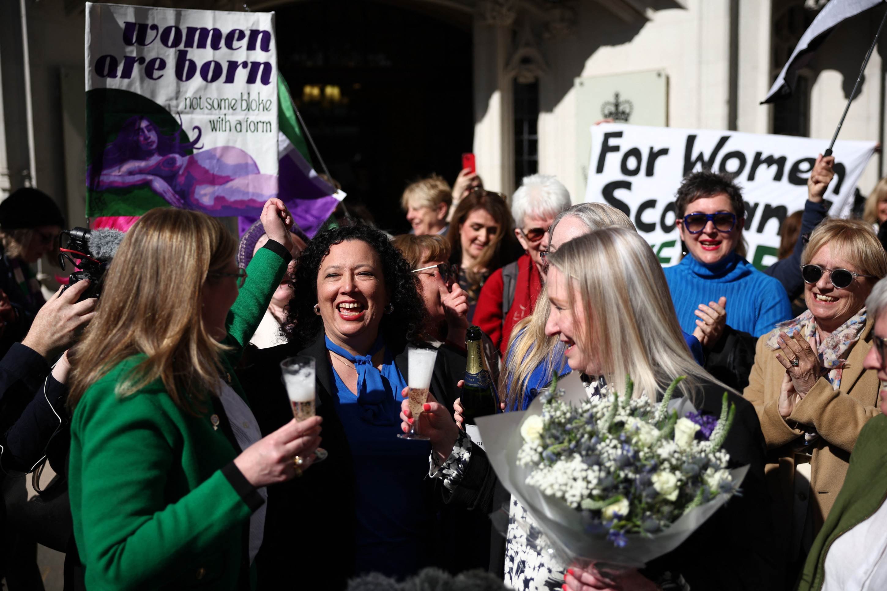  Susan Smith (L) and Marion Calder (3R), Directors of For Women Scotland, celebrate with Maya Forstater of Sex Matters outside Britains Supreme Court in London on April 16, 2025, following the courts ruling on how to define a woman. Britains Supreme Court said the legal definition of a 