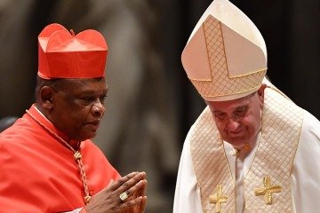 (FILES) New Cardinal Congolese prelate Fridolin Ambongo Besungu (L) reacts after being appointed by Pope Francis (R) during an Ordinary Public Consistory for the creation of new cardinals, for the imposition of the biretta, the consignment of the ring and the assignment of the Title or Diaconate, on October 5, 2019 at St. Peter's Basilica in the Vatican. As Africa's share of the Catholic population booms, mirroring its growing share of the world population as the continent grows while Europe has greyed and secularised, renewed attention has turned to whether the church is ready for its first black pope. (Photo by Tiziana FABI / AFP)
- (crédito: AFP) (FILES) New Cardinal Congolese prelate Fridolin Ambongo Besungu (L) reacts after being appointed by Pope Francis (R) during an Ordinary Public Consistory for the creation of new cardinals, for the imposition of the biretta, the consignment of the ring and the assignment of the Title or Diaconate, on October 5, 2019 at St. Peter's Basilica in the Vatican. As Africa's share of the Catholic population booms, mirroring its growing share of the world population as the continent grows while Europe has greyed and secularised, renewed attention has turned to whether the church is ready for its first black pope. (Photo by Tiziana FABI / AFP)
- (crédito: AFP)