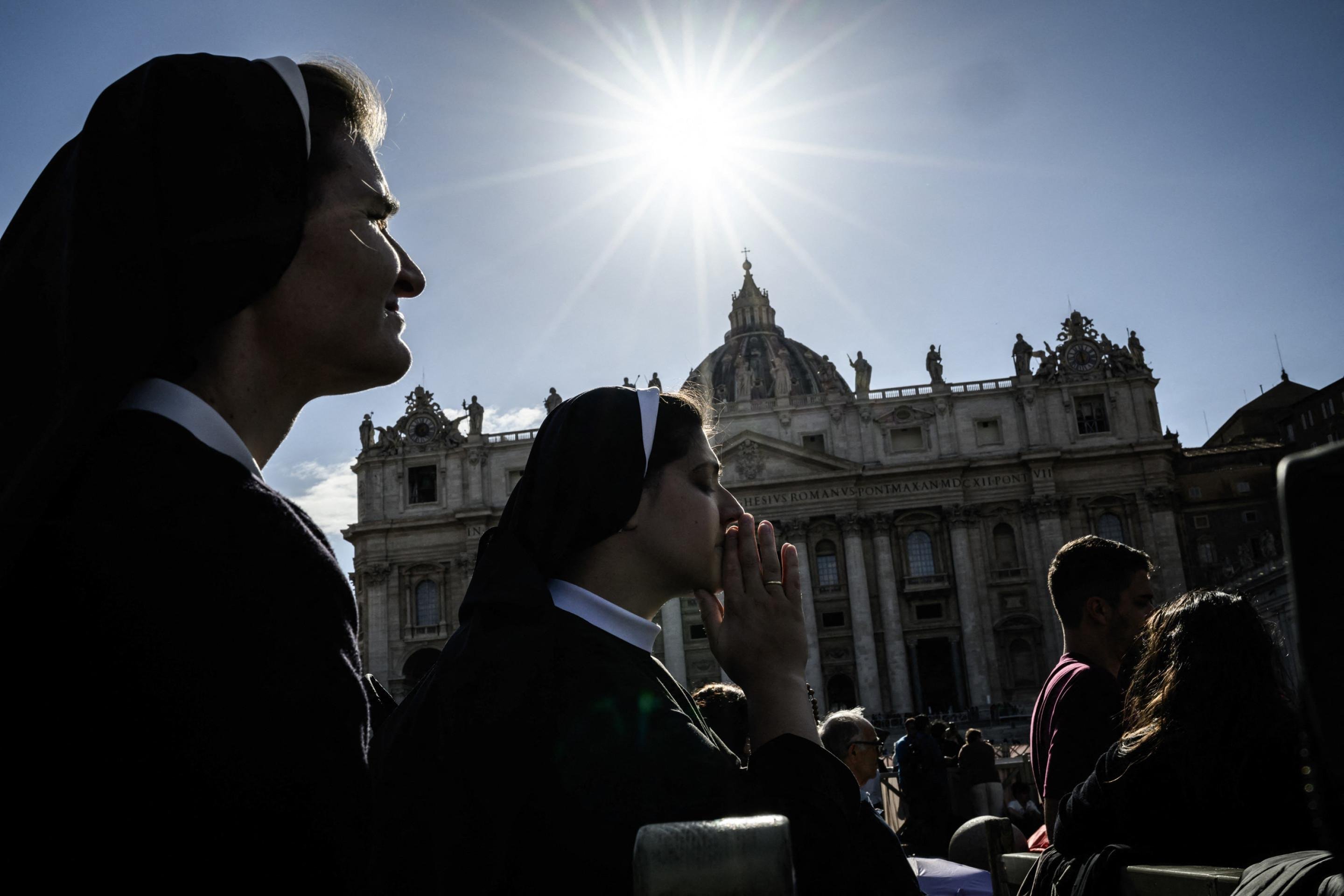  A nun prays at St Peters Square ahead of the conclave to elect the next pope, at the Vatican, on May 7, 2025. (Photo by JEFF PACHOUD / AFP)     