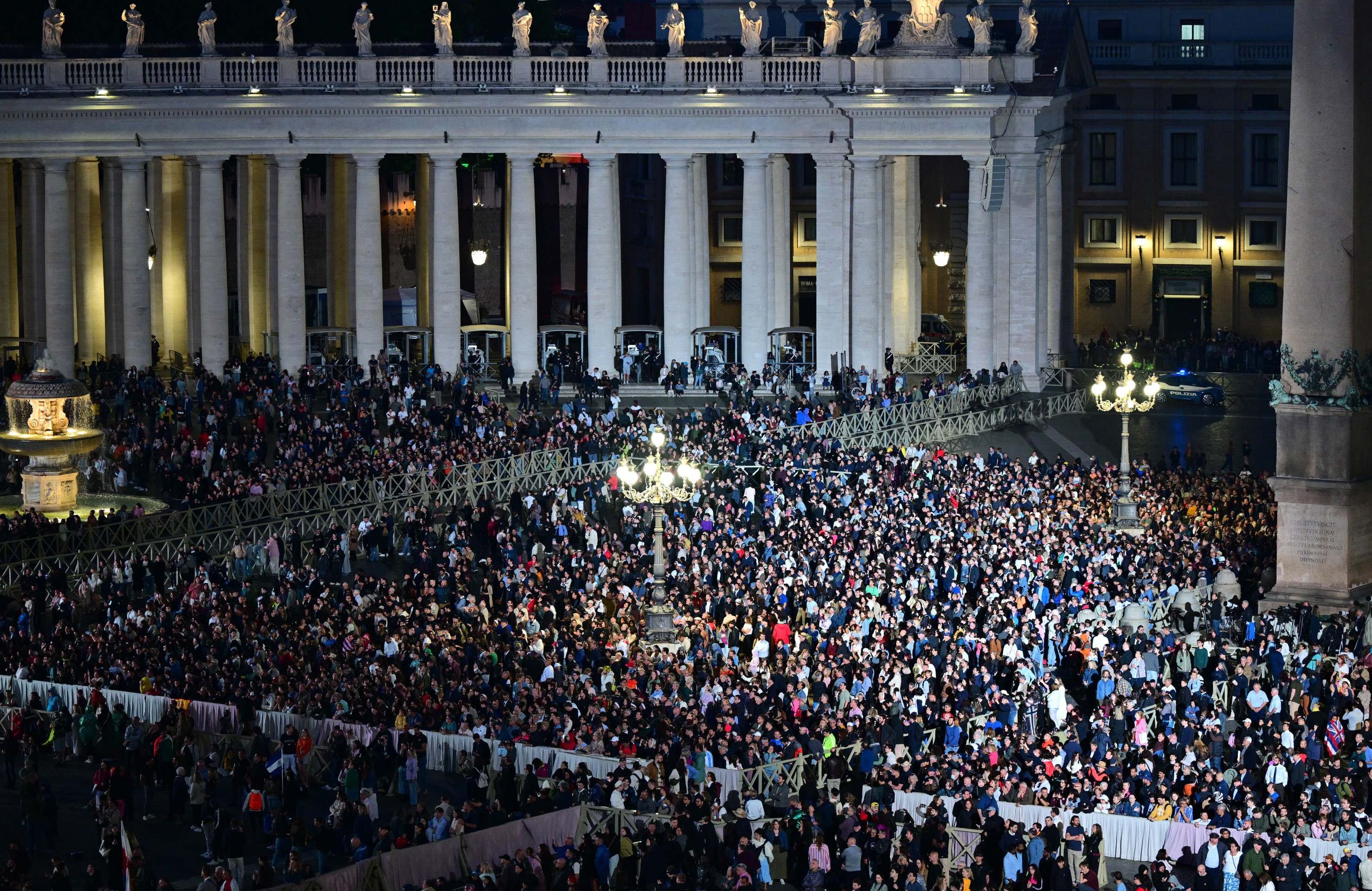  People wait at St Peters Square for smoke signalling the result of the cardinals vote during the conclave in the Vatican on May 7, 2025. (Photo by Andrej ISAKOVIC / AFP)       