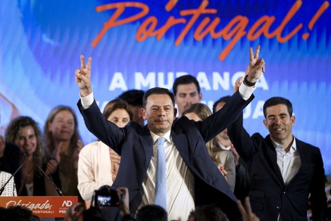 Democratic Alliance (AD) party leader and Portuguese Prime Minister Luis Montenegro celebrates his victory during the election night in Lisbon early on May 19, 2025. Portugal's incumbent centre-right party won most seats in yesterday's general election but again fell short of a ruling parliamentary majority, while for the far-right Chega party rose, near complete official results showed. With just four seats left to assign in Portugal's 230-seat parliament, the Democratic Alliance (AD) had 32.7 percent of the vote. The Socialist Party had 23.4 percent, trailed closely by Chega with 22.6 percent. (Photo by FILIPE AMORIM / AFP) - (crédito: AFP) Democratic Alliance (AD) party leader and Portuguese Prime Minister Luis Montenegro celebrates his victory during the election night in Lisbon early on May 19, 2025. Portugal's incumbent centre-right party won most seats in yesterday's general election but again fell short of a ruling parliamentary majority, while for the far-right Chega party rose, near complete official results showed. With just four seats left to assign in Portugal's 230-seat parliament, the Democratic Alliance (AD) had 32.7 percent of the vote. The Socialist Party had 23.4 percent, trailed closely by Chega with 22.6 percent. (Photo by FILIPE AMORIM / AFP) - (crédito: AFP)