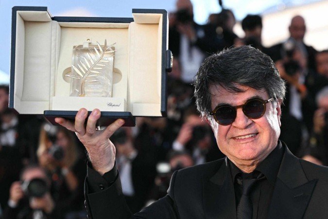  Iranian director and screenwriter and producer Jafar Panahi poses with the trophy during a photocall after winning the Palme d'Or for the film 